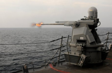 US Navy 111101-N-XQ375-405 The MK 38 25mm machine gun aboard the guided-missile destroyer USS Mitscher (DDG 57)fires during a gunnery exercise