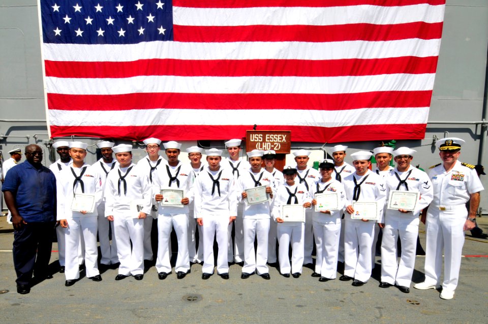 US Navy 111031-N-KM175-096 Sailors pose for a group photo after a naturalization ceremony where 18 Sailors became U.S. citizens