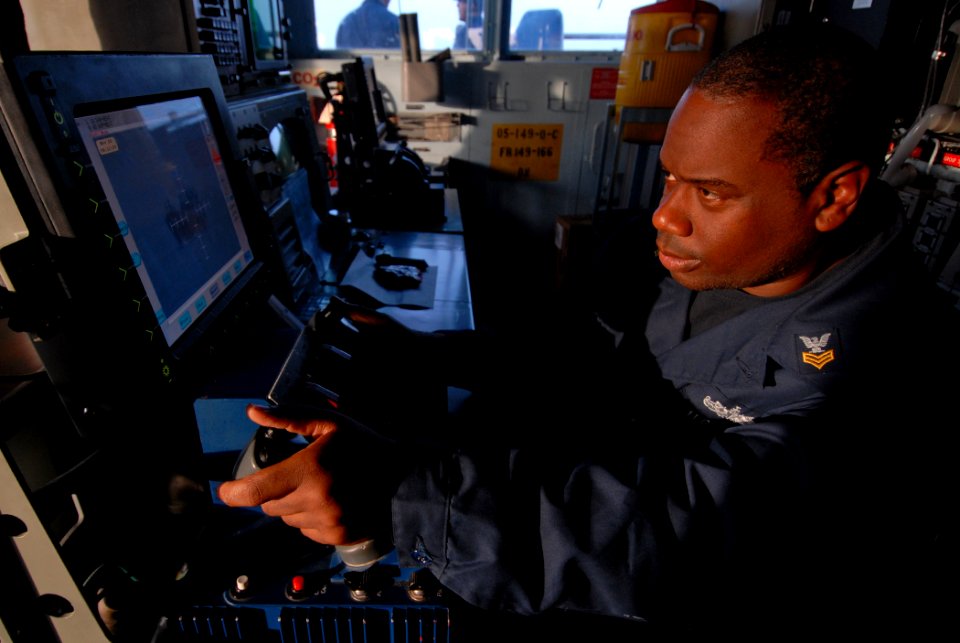 US Navy 111105-N-DU438-055 Gunners Mate 1st Class Jackie Marshall stands a watch in the ship's pilot house on the remote station