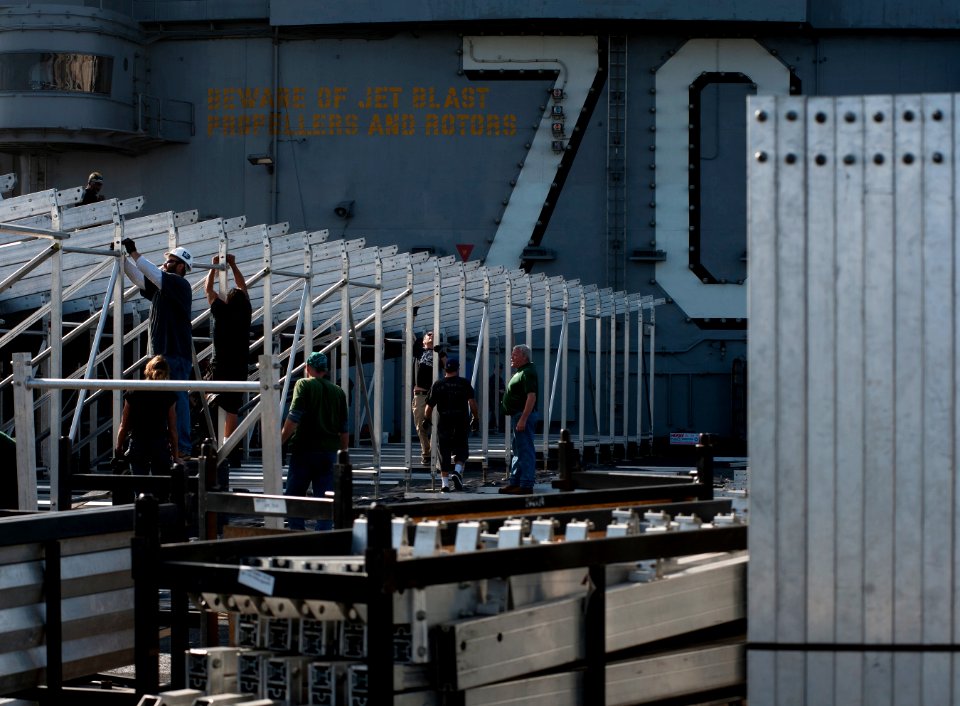 US Navy 111103-N-DR144-300 Civilian contractors assemble bleachers while building a basketball arena on the flight deck of the Nimitz-class aircraf