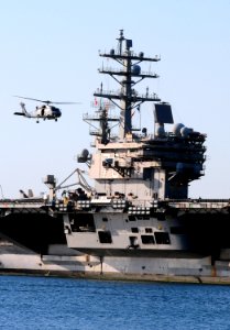US Navy 111103-N-KB563-161 An SH-60S Sea Hawk helicopter flies above the aircraft carrier USS Ronald Reagan (CVN 76) as it returns to homeport