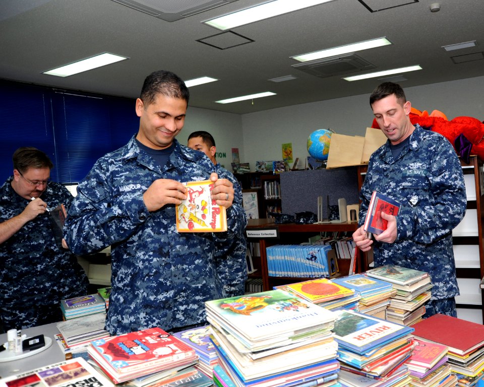 US Navy 111103-N-KK192-003 Sailors prepare library books for disposal at Cummings Elementary as part of a community service project