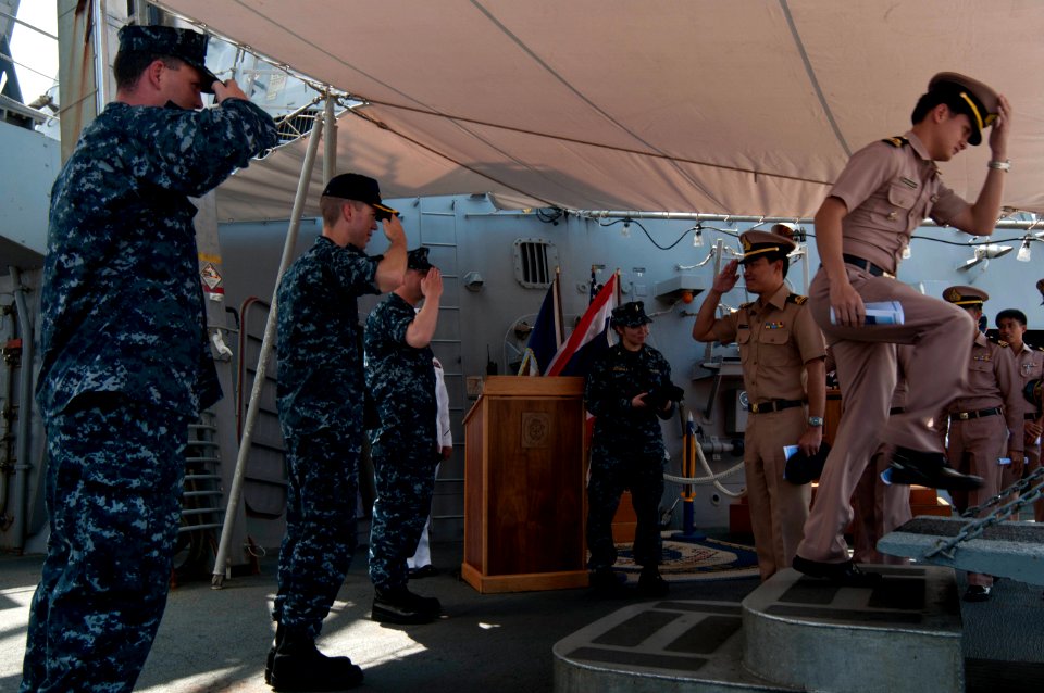 US Navy 111101-N-EA192-081 Royal Thai Navy sailors salute the aboard the guided-missile destroyer USS Mustin (DDG 89) as they depart the ship afte