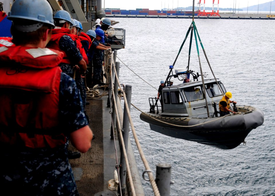 US Navy 111101-N-WJ771-098 Sailors assigned to the forward-deployed amphibious dock landing ship USS Germantown (LSD 42) lower a rigid-hull inflata