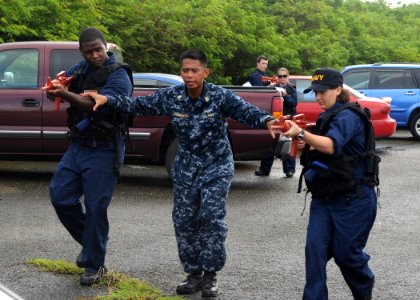 US Navy 111103-N-UE250-099 A chief instructs Sailors on how to move while carrying their weapons