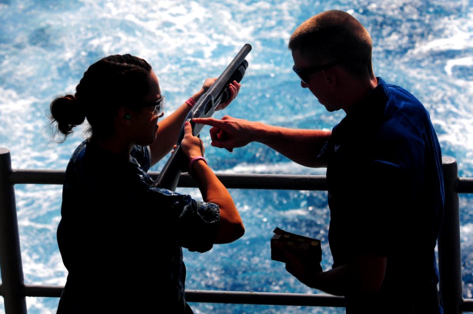 US Navy 111031-N-UO379-126 Gunner's Mate 3rd Class John Thurman, from Riverside, Calif., instructs Interior Communications Specialist 3rd Class Jes