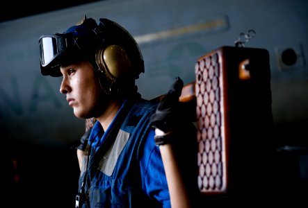 US Navy 111029-N-VN693-319 Aviation Boatswain's Mate (Handling) Airman Edward Martinez, from Hesperia, Calif., prepares to chock and chain an EA-6B
