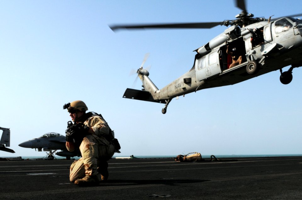 US Navy 111101-N-JD217-329 Explosive Ordnance Disposal 2nd Class Bradley Kelly takes a tactical position after rappelling from an MH-60S Sea Hawk h