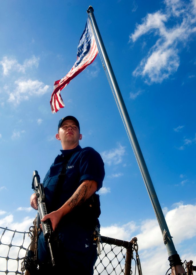 US Navy 111030-N-FI736-160 A Sailor stands watch on the flight deck of the guided-missile destroyer USS Arleigh Burke (DDG 51)