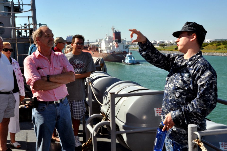 US Navy 111104-N-YX169-080 Electronics Technician 2nd Class Patrick Smith answers questions from visitors while conducting a tour of the amphibious