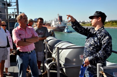 US Navy 111104-N-YX169-080 Electronics Technician 2nd Class Patrick Smith answers questions from visitors while conducting a tour of the amphibious