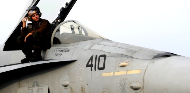 US Navy 111030-N-OY799-195 Aviation Structural Mechanic Airman Morgan Angle stands by an F-A-18C Hornet from the Golden Dragons of Strike Fighter S