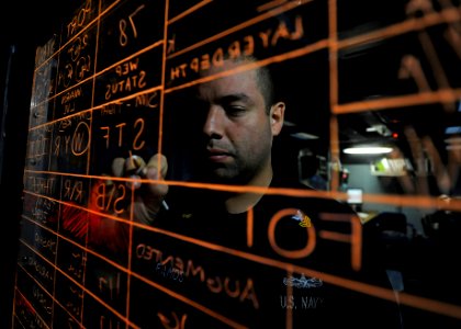 US Navy 111102-N-VH839-091 Sonar Technician (Surface) 1st Class Carlos Ramos, from Whittier, Calif., updates information on the status panel aboard