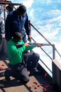 US Navy 111031-N-UO379-051 Aviation Boatswain's Mate (Equipment) Airman Jovon Dupree, from Clarksville, N.C., fires a Mossberg 500 shotgun
