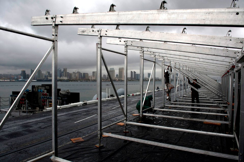 US Navy 111104-N-DR144-018 Civilian contractors assemble bleachers while constructing a basketball arena aboard Nimitz-class aircraft carrier USS C