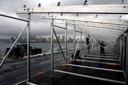 US Navy 111104-N-DR144-018 Civilian contractors assemble bleachers while constructing a basketball arena aboard Nimitz-class aircraft carrier USS C