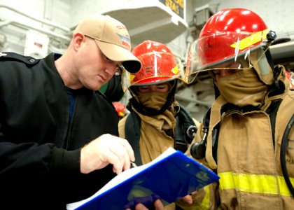 US Navy 111102-N-NR955-021 Chief Information Systems Technician Matt Mattera instructs Sailors during a general quarters drill aboard USS Iwo Jima
