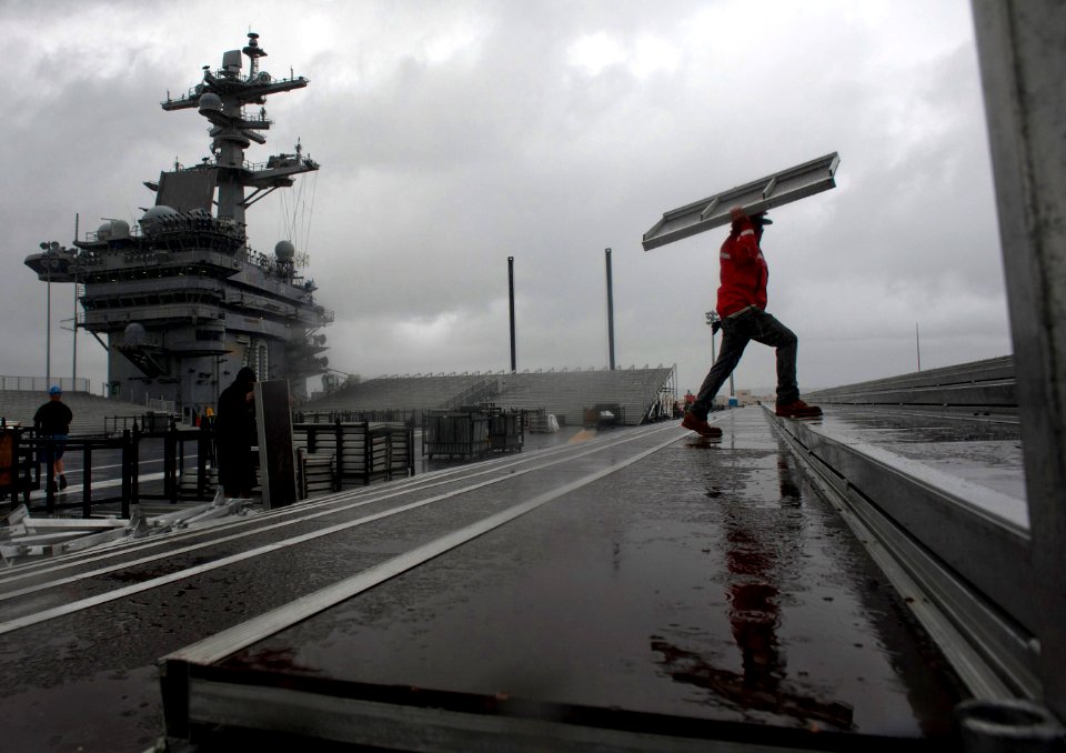 US Navy 111104-N-DR144-057 Civilian contractors assemble bleachers while constructing a basketball arena aboard Nimitz-class aircraft carrier USS C