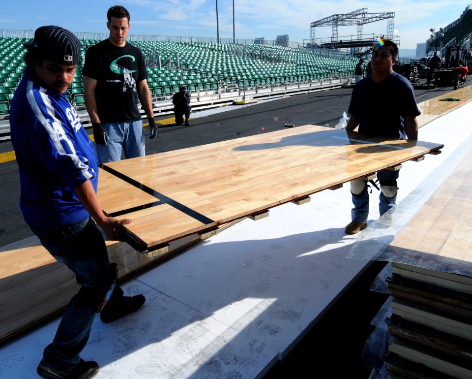 US Navy 111108-N-RG587-128 McWil Sport Surfaces employees begin laying the hardwood floor for a basketball court aboard the Nimitz-class aircraft c