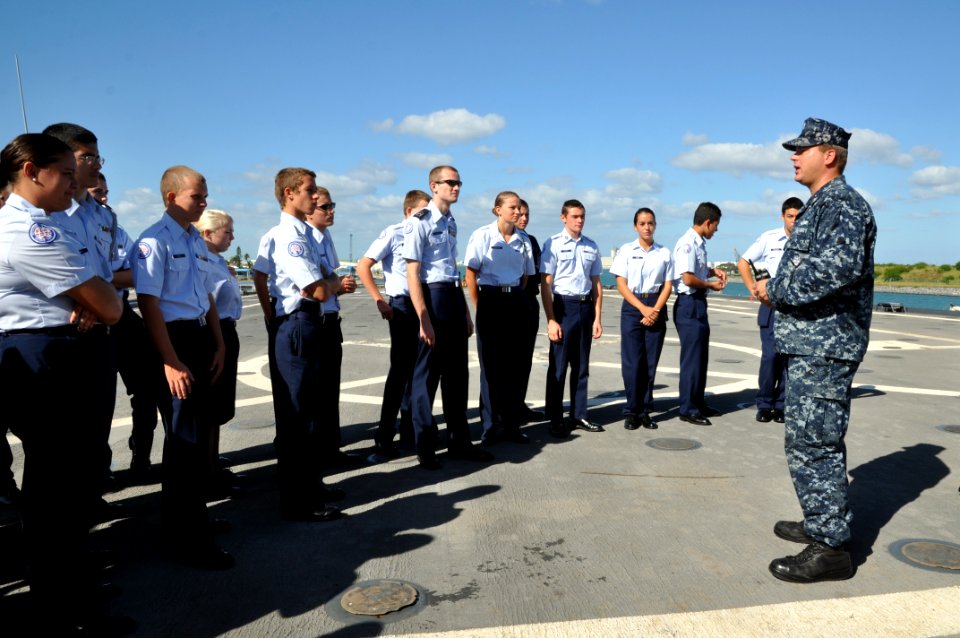 US Navy 111102-N-YX169-031 Logistics Specialist 2nd Class Peter Kelly explains flight deck operations aboard the amphibious transport dock ship USS