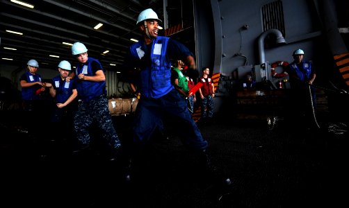 US Navy 111103-N-OY799-195 Sailors aboard the Nimitz-class aircraft carrier USS John C. Stennis (CVN 74) heave a messenger line from fast combat su