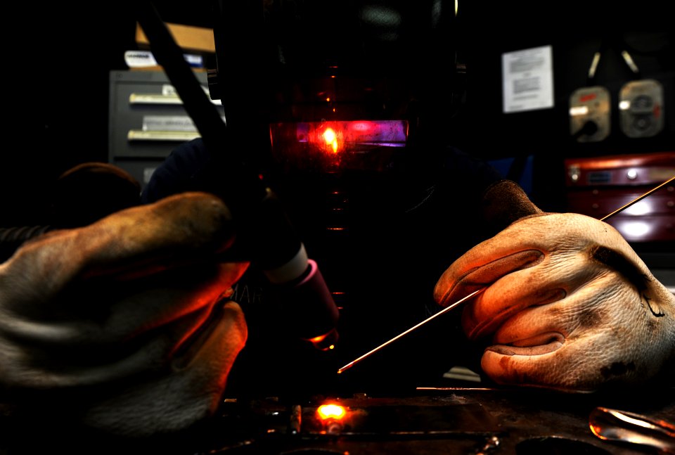 US Navy 111104-N-XE109-154 Hull Technician Fireman Preston S. Bomar welds a piece of stainless steel to carbon aboard the aircraft carrier USS Geor