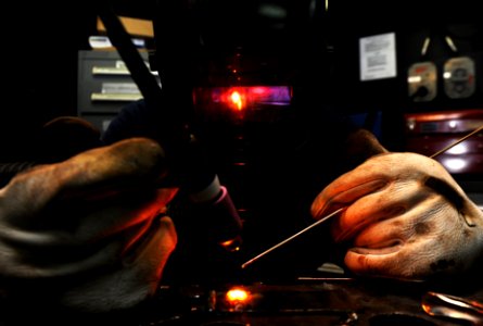 US Navy 111104-N-XE109-154 Hull Technician Fireman Preston S. Bomar welds a piece of stainless steel to carbon aboard the aircraft carrier USS Geor
