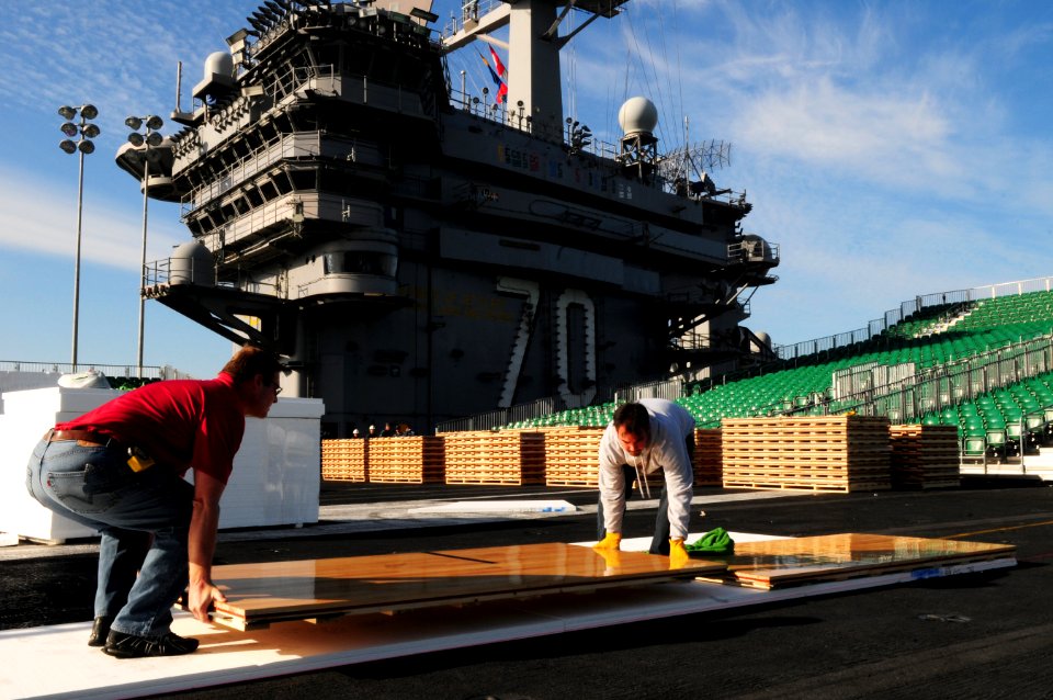 US Navy 111108-N-SB672-008 McWil Sport Surfaces employees begin laying the hardwood floor for a basketball court aboard the Nimitz-class aircraft c