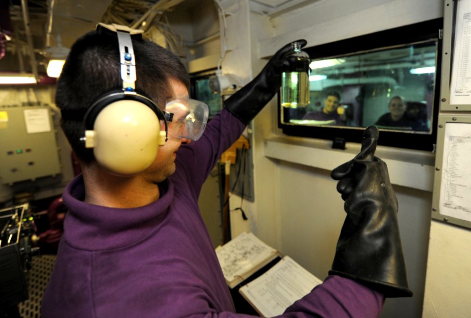 US Navy 111108-N-TB177-048 Aviation Boatswain's Mate (Fuel) Airman John H. Kindle gives the signal for a good fuel sample aboard the aircraft carri