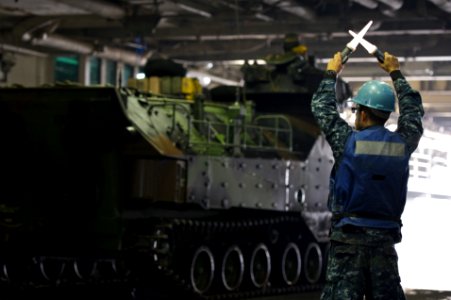US Navy 111108-N-ZC343-399 A Sailor assigned to the amphibious assault ship USS Bonhomme Richard (LHD 6) guides amphibious assault vehicles into th