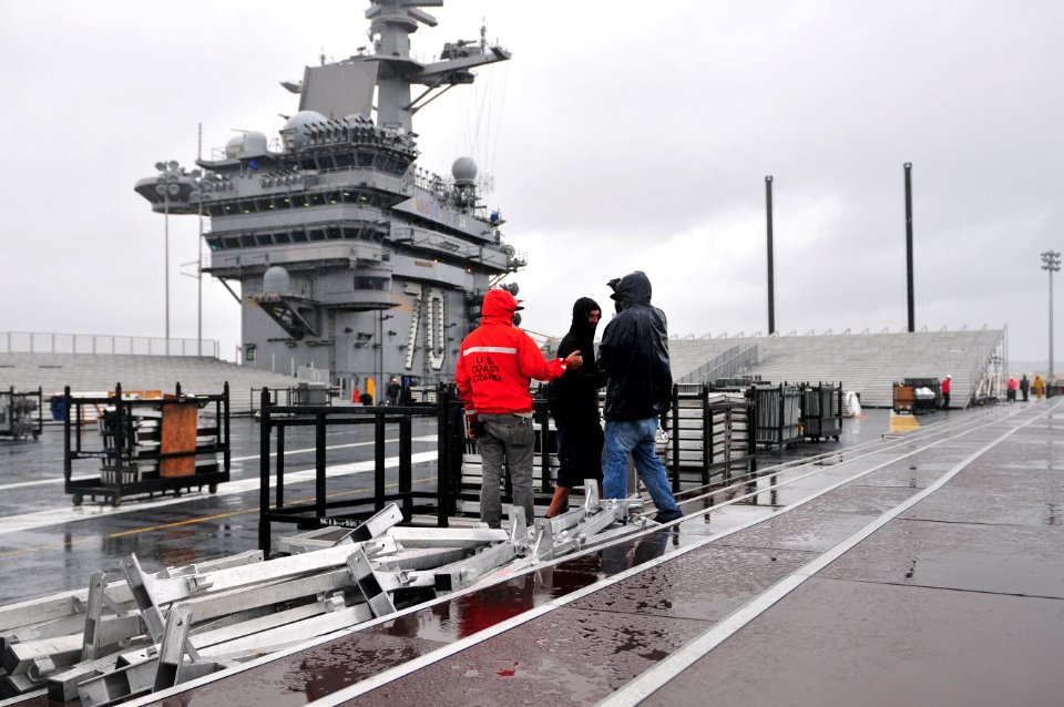 US Navy 111104-N-ZI635-032 Civilian contractors assemble bleachers while constructing a basketball arena aboard Nimitz-class aircraft carrier USS C