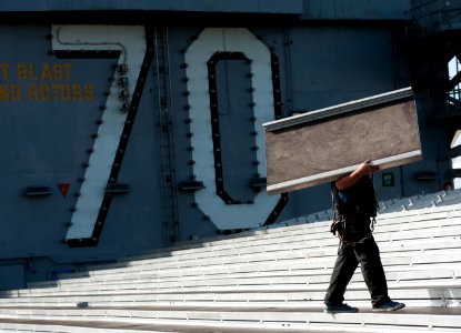 US Navy 111103-N-DR144-436 Civilian contractors assemble bleachers while building a basketball arena on the flight deck of the Nimitz-class aircraf