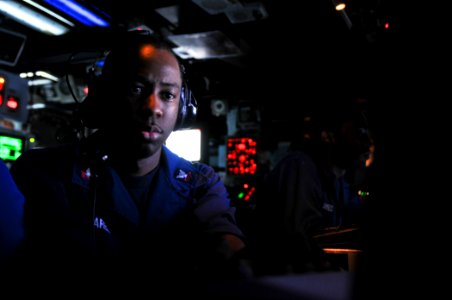 US Navy 111103-N-YM590-024 Operations Specialist 2nd Class Rory Harel stands global command and control system-maritime watch in the Combat Informa
