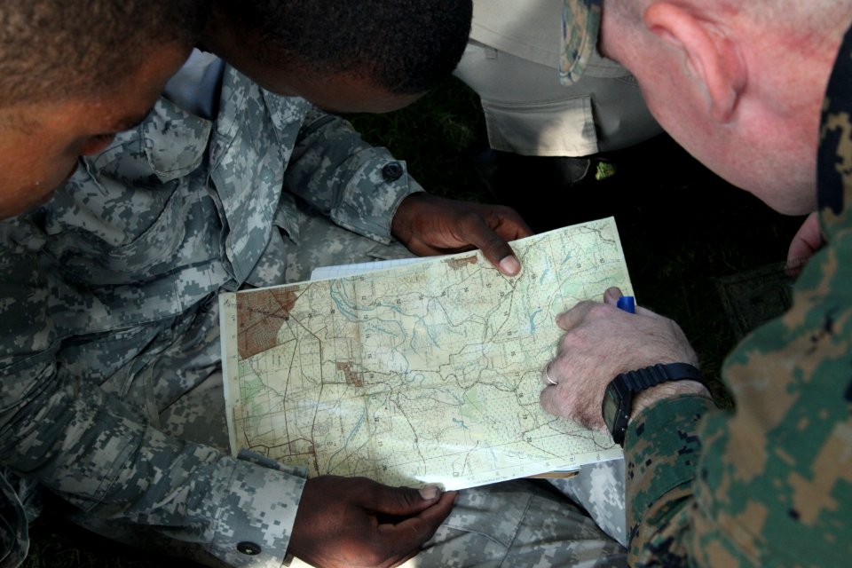 US Navy 111110-A-IP644-166 Sgt. Mark Miller exchanges basic land navigation techniques with Dominican Marines