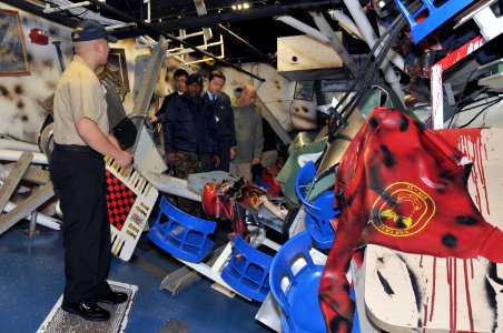 US Navy 111108-N-IK959-515 Electrician's Mate 1st Class Jerry Gonzales explains a simulated damaged berthing compartment aboard the 210-foot-long A