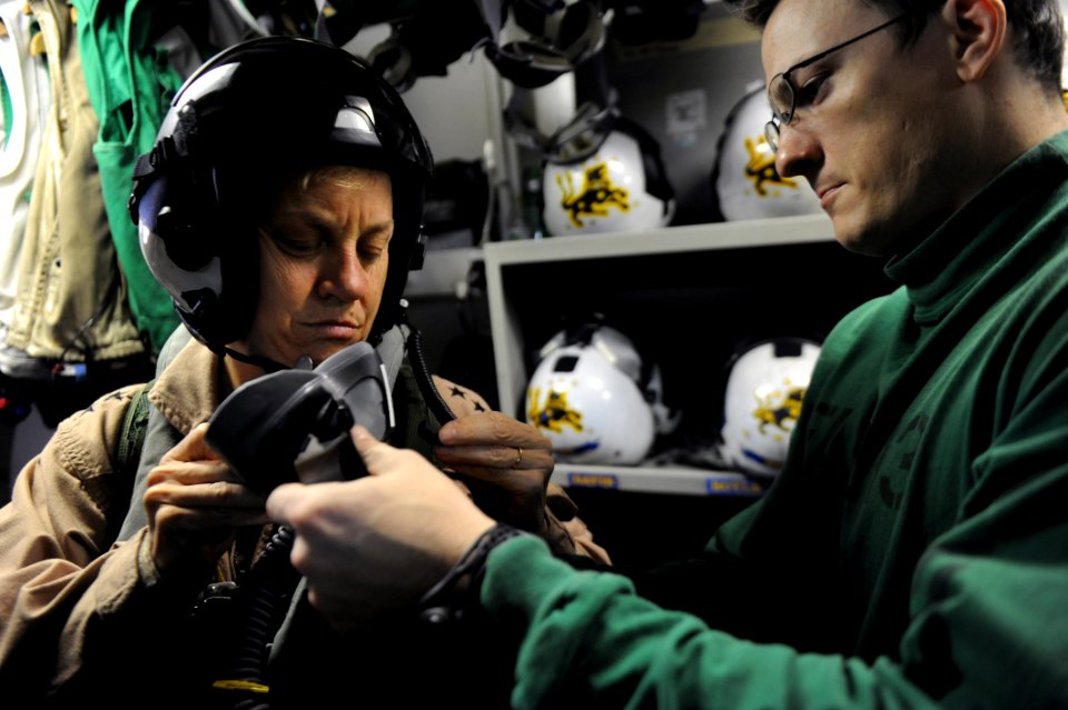 US Navy 111103-N-XE109-124 Rear Adm. Nora W. Tyson, commander of Carrier Strike Group (CSG) 2, adjusts her flight mask before a launch aboard the a