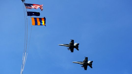 US Navy 111107-N-OY799-013 F-A-18E Super Hornets from the Tophatters of Strike Fighter Squadron (VFA) 14 fly past USS John C. Stennis