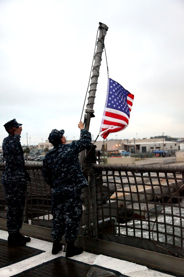 US Navy 111104-A-IP644-004 Logistics Specialist 1st Class Eric Jones and Yeoman Marlon Garcia shift colors aboard High Speed Vessel (HSV 2) Swift a