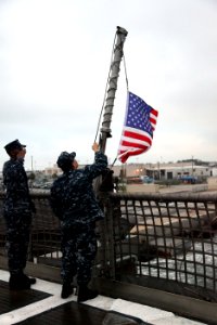 US Navy 111104-A-IP644-004 Logistics Specialist 1st Class Eric Jones and Yeoman Marlon Garcia shift colors aboard High Speed Vessel (HSV 2) Swift a