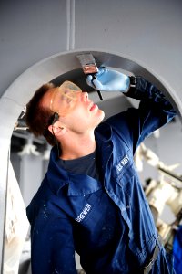 US Navy 111106-N-QL471-061 Boatswain's Mate Seaman David J. Brewer paints a bulkhead aboard the aircraft carrier USS George H.W. Bush (CVN 77