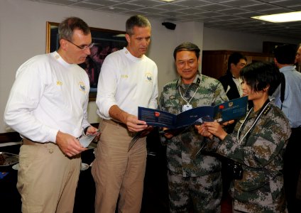 US Navy 111108-N-JO245-292 Maj. Gen. Zhou Songhe, Chief of Staff, PLA Forces Hong Kong, and PLA Capt. Guo Binying present Capt. David A. Lausman wi