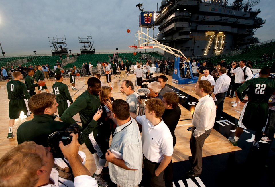 US Navy 111110-N-DR144-582 Reporters interview Michigan State University basketball player Draymond Green during a practice in the basketball arena