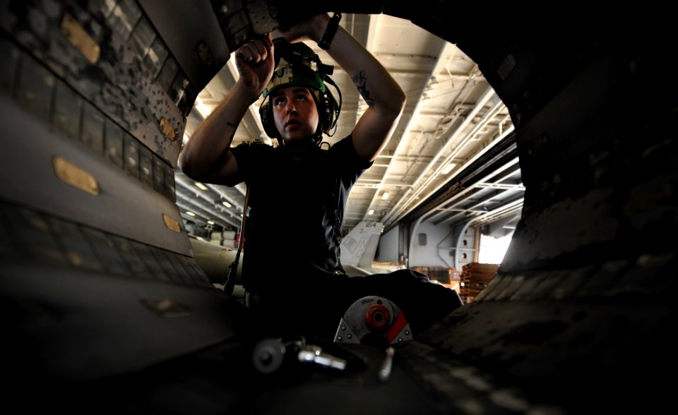 US Navy 111108-N-OY799-110 Aviation Machinist's Mate 3rd Class Erik Meade repairs a variable exhaust nozzle on an F-A-18F Super Hornet aboard USS J