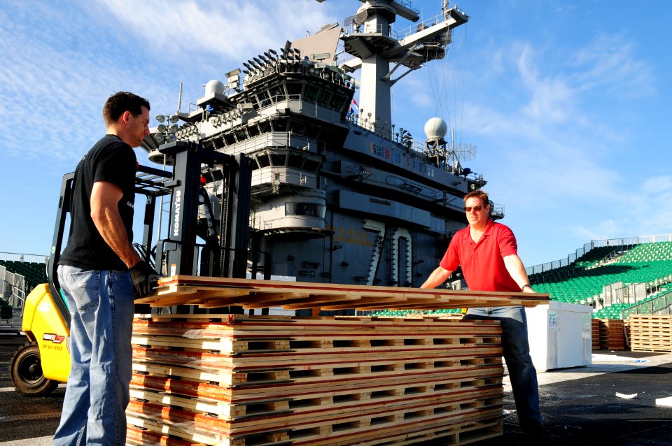 US Navy 111108-N-SB672-041 McWil Sport Surfaces employees begin laying the hardwood floor for a basketball court aboard the Nimitz-class aircraft c