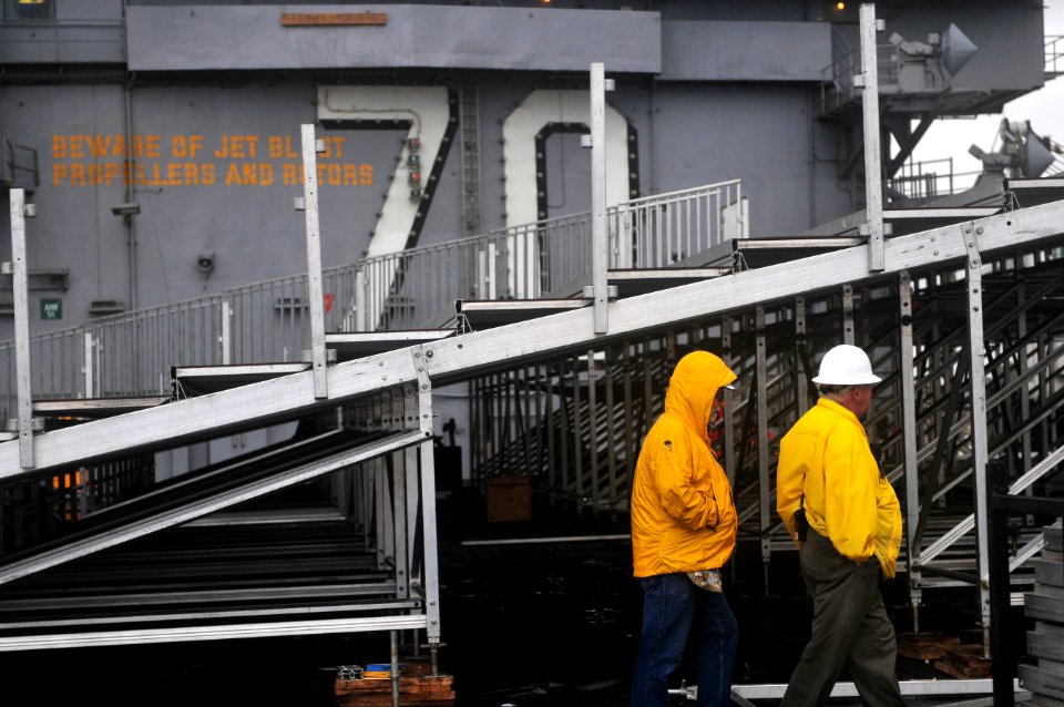 US Navy 111104-N-ZI635-066 Civilian contractors assemble bleachers while constructing a basketball arena aboard Nimitz-class aircraft carrier USS C