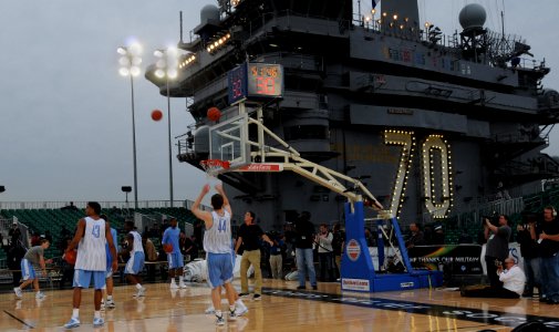 US Navy 111110-N-RG587-183 The University of North Carolina Tar Heels take practice shots on the basketball arena on the flight deck aboard Nimitz
