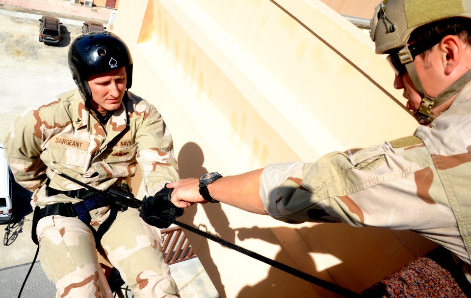 US Navy 111110-N-RP435-010 Navy Diver 2nd Class Jason M. Sargeant is directed to extend his right arm to control speed during rappel training on Na