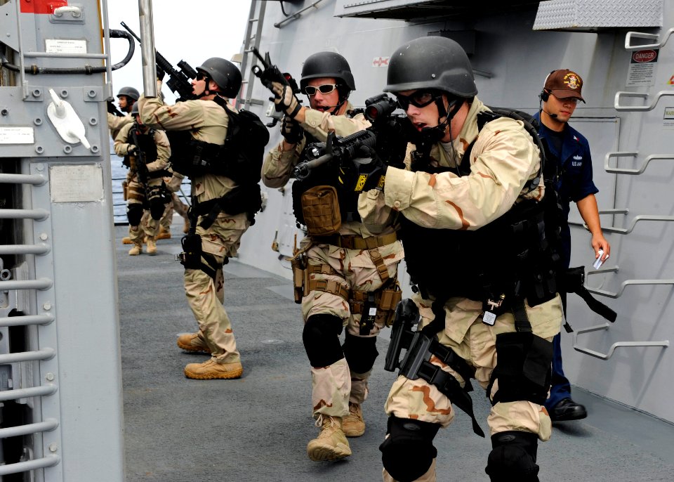 US Navy 111108-N-VH839-019 Fire Controlman 3rd Class Matthew Keen leads his visit, board, search, and seizure (VBSS) team members to the forecastle