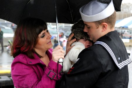 US Navy 111110-N-UM744-002 Machinist's Mate 1st Class Paul Rich hugs his 14-week old son for the first time