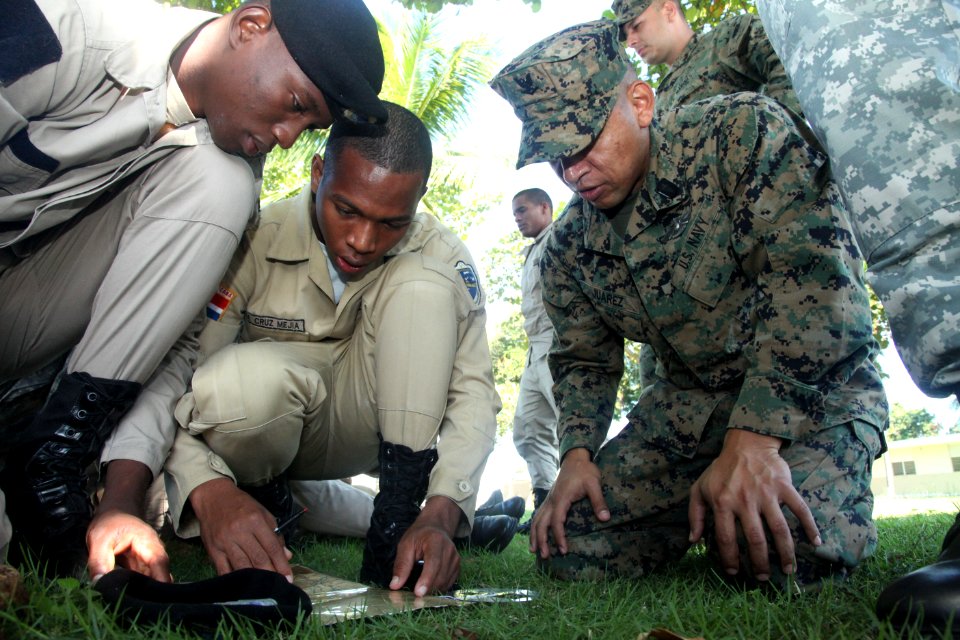 US Navy 111110-A-IP644-184 Hospital Corpsman 3rd Class Jorge Juarez exchanges basic land navigation techniques with Dominican marines